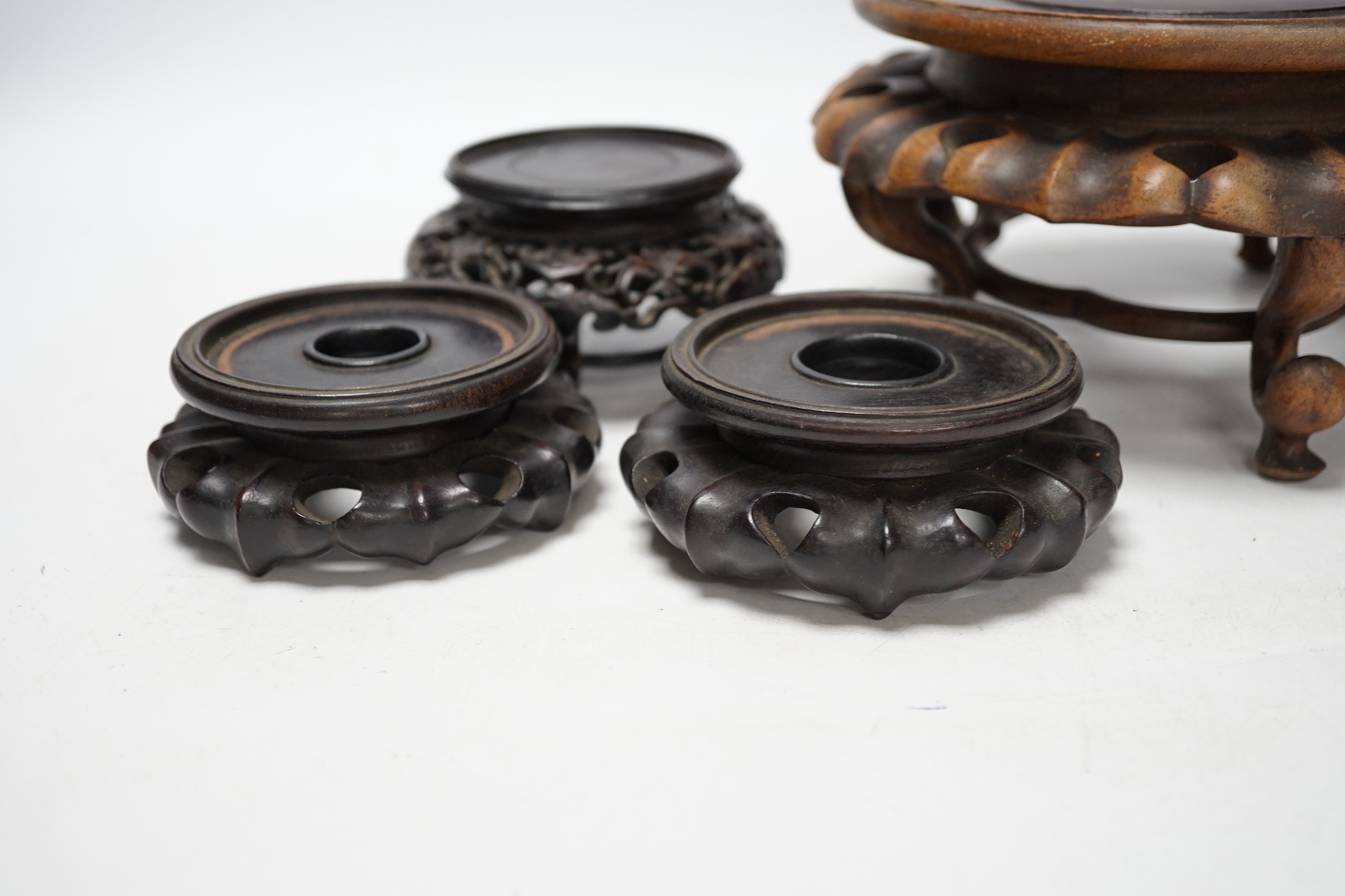 Four Chinese 19th/early 20th century rosewood stands, tallest 10.5cm high